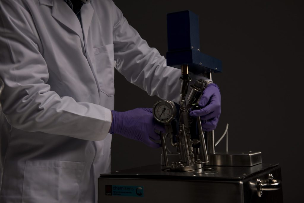 A photograph of a chemists assembling a Syrris Chemisens Calorimeter
